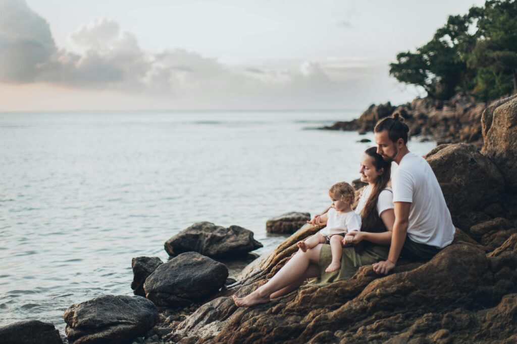 pexels-photo-1914982-1914982 A serene family moment by the seaside, capturing love and relaxation at sunset.